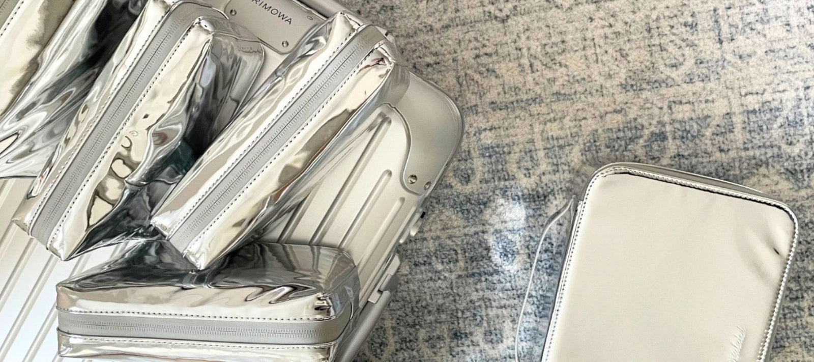 silver-travel-makeup-bags-on-rimowa-suitcase
